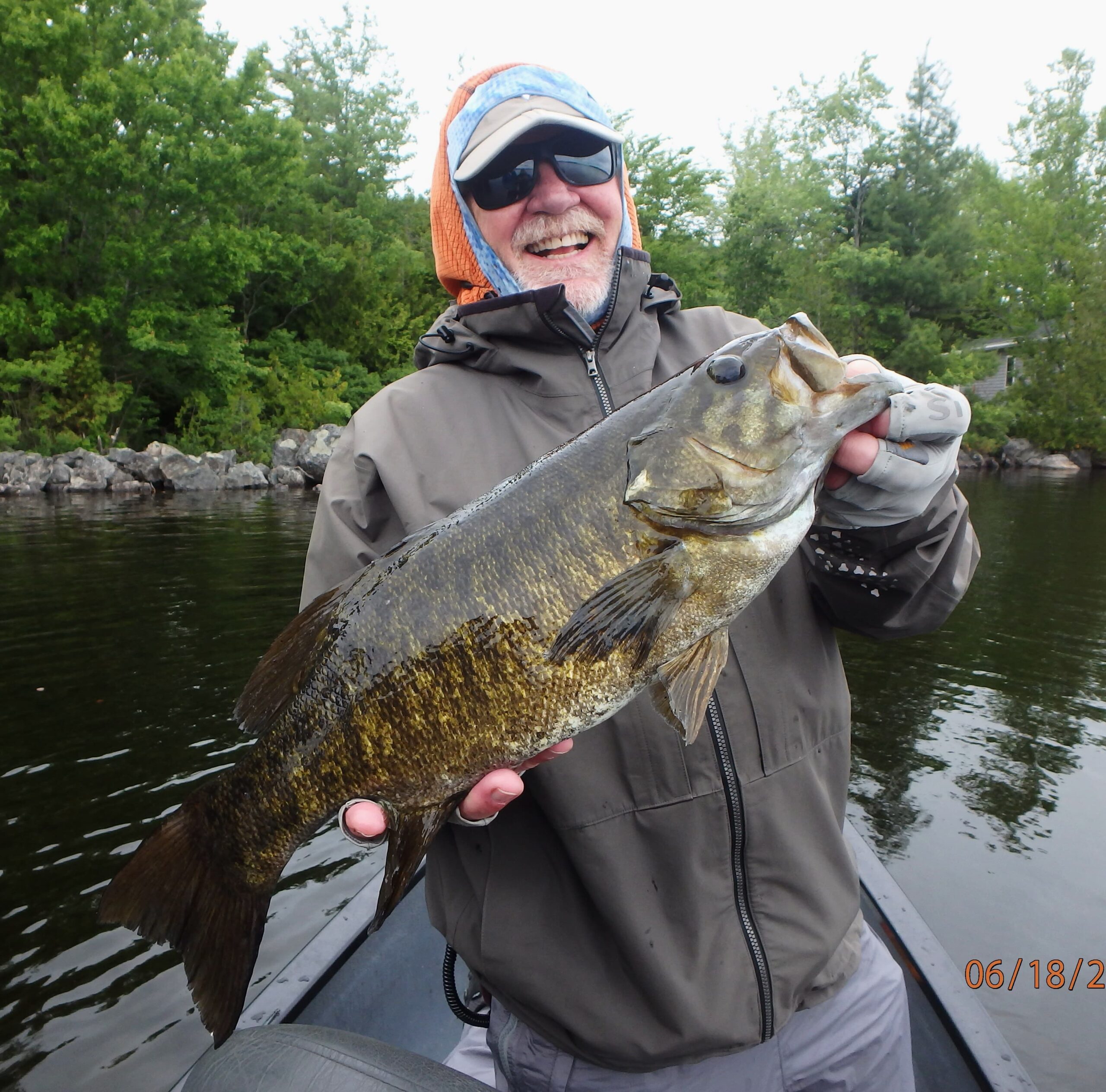 Man holding a freshly caught Smallmouth Bass.